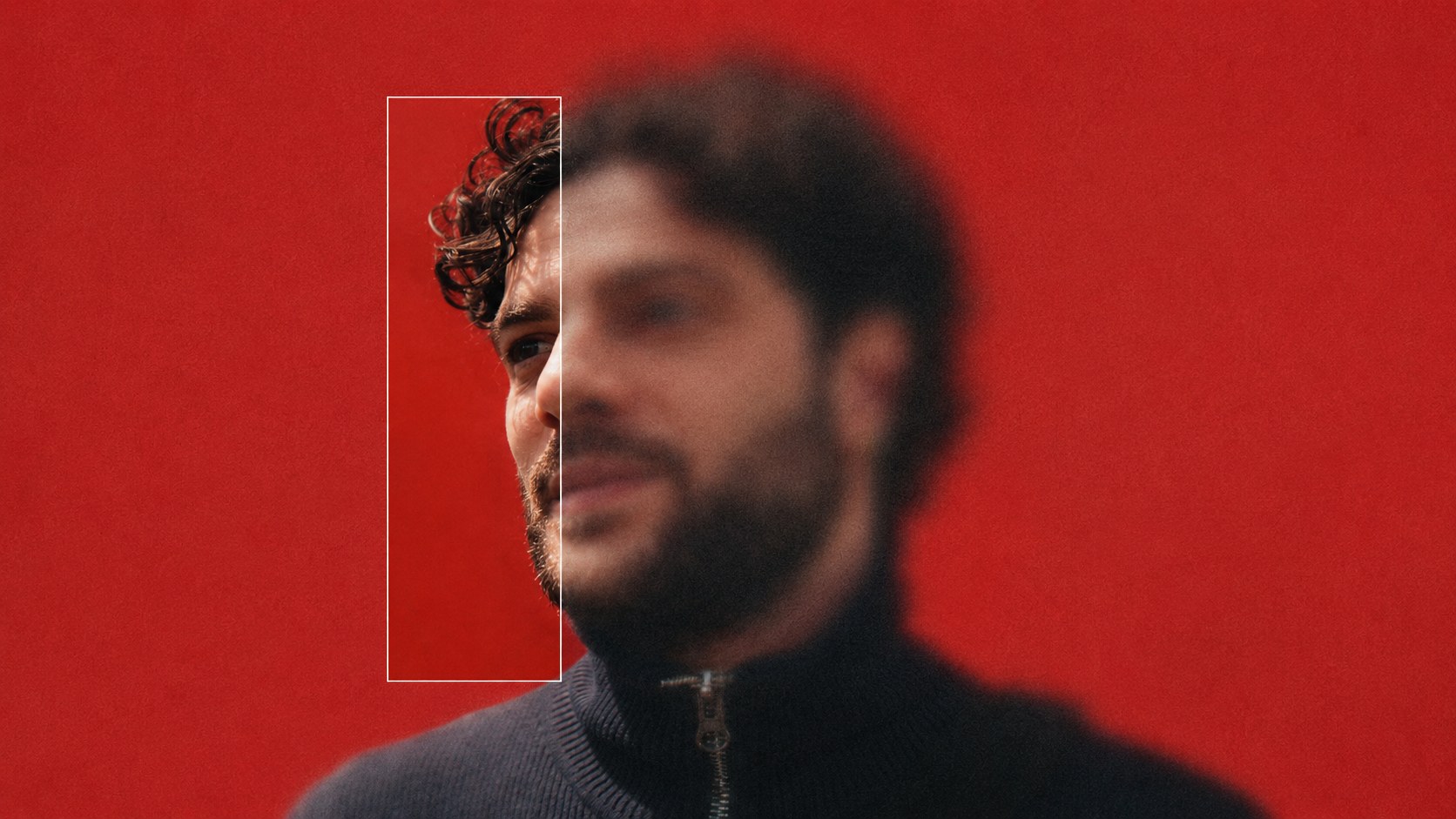 A man's portrait on a red wall